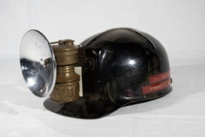 Photograph of a black helmet with a light attached to the front.