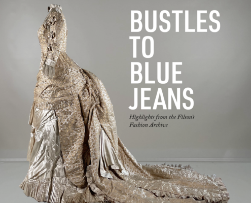 Elegant, vintage gown with intricate lace detailing and a long train, set against a neutral background. Text reads "Bustles to Blue Jeans."