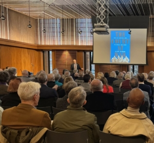 Image of lecture at the Filson historical society. Lecturer standing at front of room speaking with audience stilling and listening.