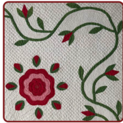 Quilt with red and pink flower centerpiece, green vine, and leaves on a textured white background. Elegant, floral design with intricate patterns.